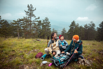 Happy family laughing together on a mountain hiking break