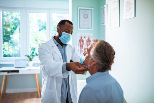 Doctor examining elderly male patient in medical office