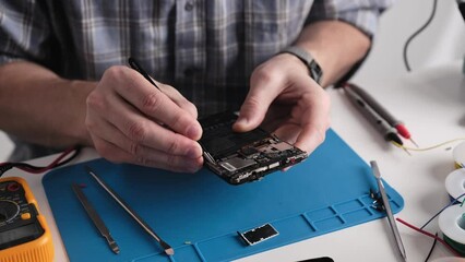 Service Technician Fixing Broken Smartphone In Service Repair Center