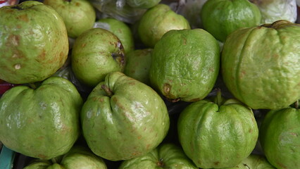Ripe and fresh green guavas are sold at street fruit stalls