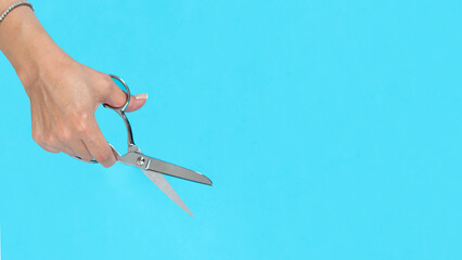hand holding scissors