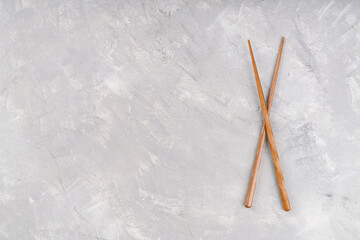 Chinese chopsticks on a blank gray background, top view, copy space