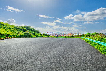 Asphalt road and port container terminal landscape on a sunny day