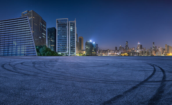 Fototapeta Asphalt road square and modern city buildings at night in Chongqing. Panoramic view.