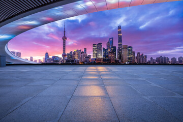 Empty square floor and bridge with modern city buildings scenery at night in Shanghai