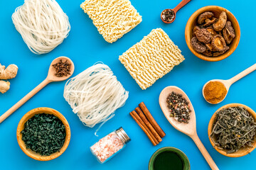 Rice vermicelli, noodles, spices, weeds pattern to cook Chinese and Japanese food on blue...