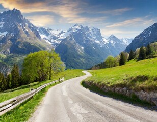 Fototapeta premium transport road in the Alps against the backdrop of snow-capped mountains and forest