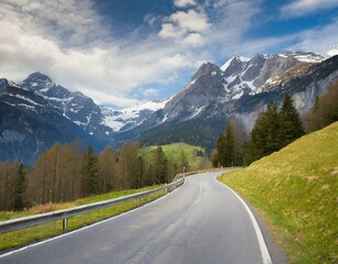 Naklejka premium transport road in the Alps against the backdrop of snow-capped mountains and forest