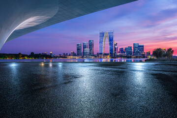 Asphalt road square and bridge with modern city buildings scenery at night in Suzhou