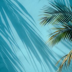 Fototapeta premium Palm leaves casting beautiful shadows on a pastel blue wall, creating a tropical and serene atmosphere.