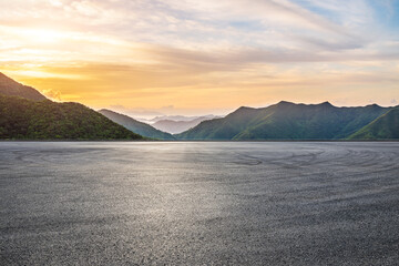 Asphalt road square and green mountain with sky clouds natural landscape at sunrise