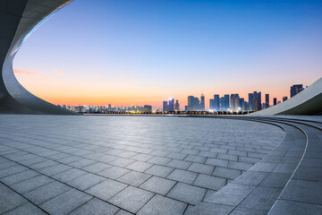 Empty square floor and city skyline with modern buildings at sunrise © ABCDstock