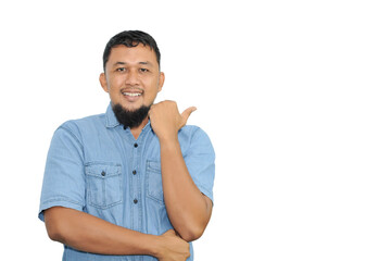 Photo of man wear blue jeans pointing fingers empty space isolated blue color background