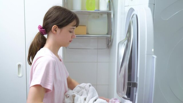 Teenager girl doing laundry at her home