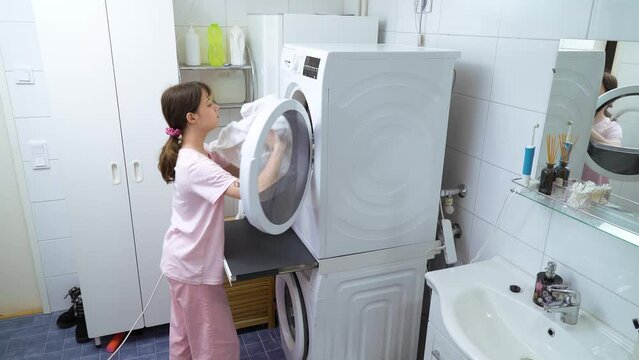 Teenager girl doing laundry at her home