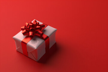 Obraz premium White gift box with red ribbon on red background with copy space