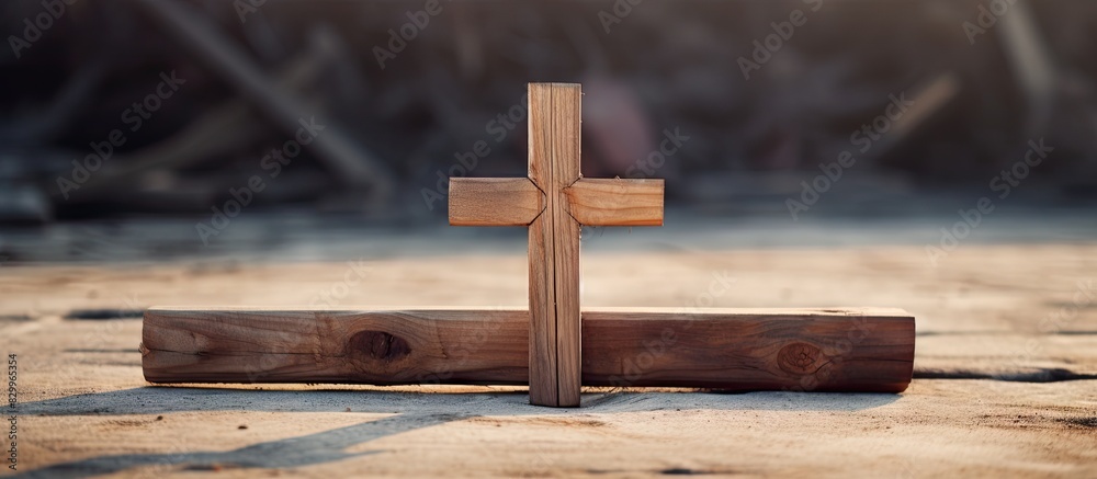 Aufkleber a cross made of wood is positioned on the ground providing ample copy space in the image