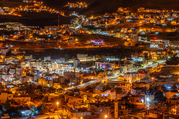 Vibrant Nighttime View of Wadi Musa, Jordan - Illuminated Cityscape Near Petra with Twinkling Lights