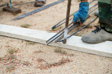 worker's hand, bending steel bars  traditional tools
