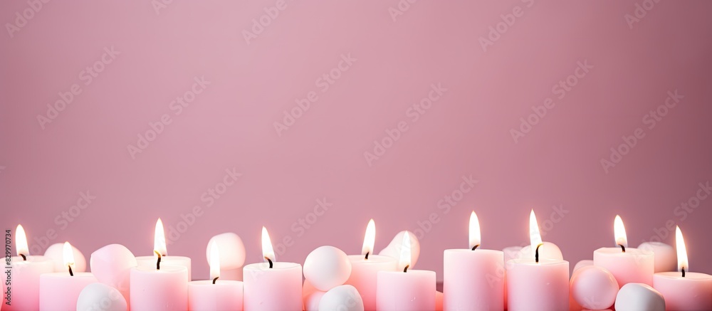 Poster The pink pastel candles and marshmallows are arranged in a top view on a pink pastel background creating a captivating copy space image