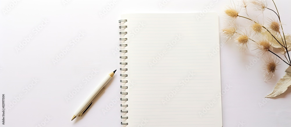 Aufkleber Aesthetic copy space image of a notebook and pen resting on a pristine white table