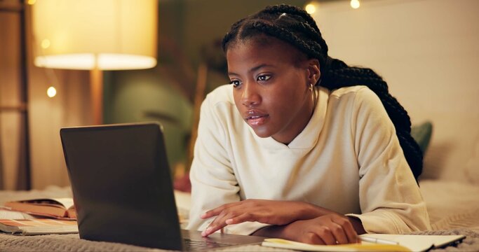 Education, laptop and night with black woman on bed in home for distance learning or remote study. Computer, evening research and notebook with college or university person in bedroom of apartment