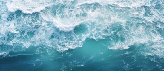 A top down view of ocean waves creating water patterns suitable as a background image with copy space