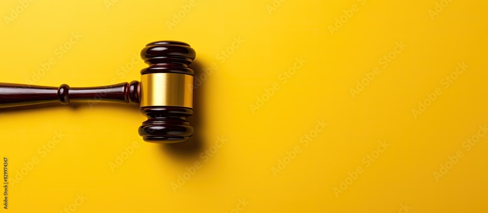 Poster top down copy space image featuring a judge s gavel on a yellow background symbolizing the concept o