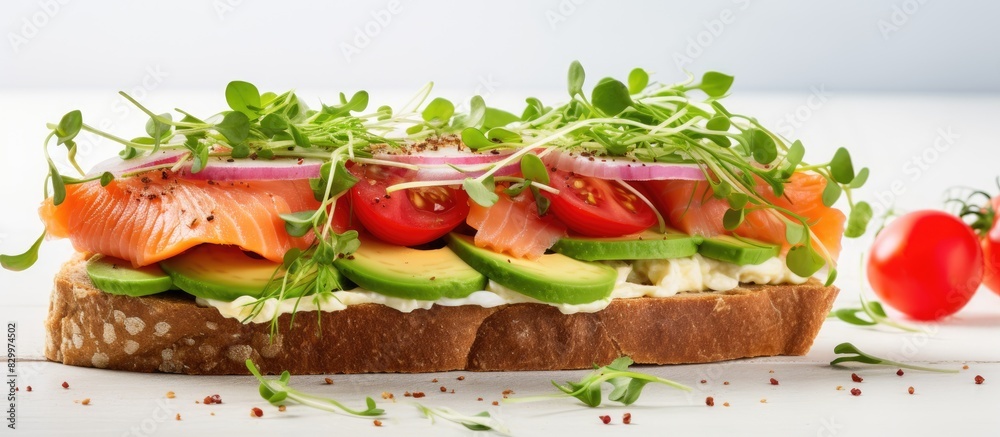 Poster a nutritious sandwich comprising of fresh avocado salmon gluten free grain bread green onions radish