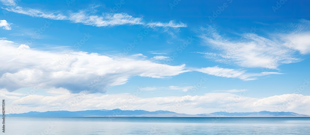 Wall mural a picturesque landscape of qinghai lake with a panoramic view showcasing the serene bluesky and tran