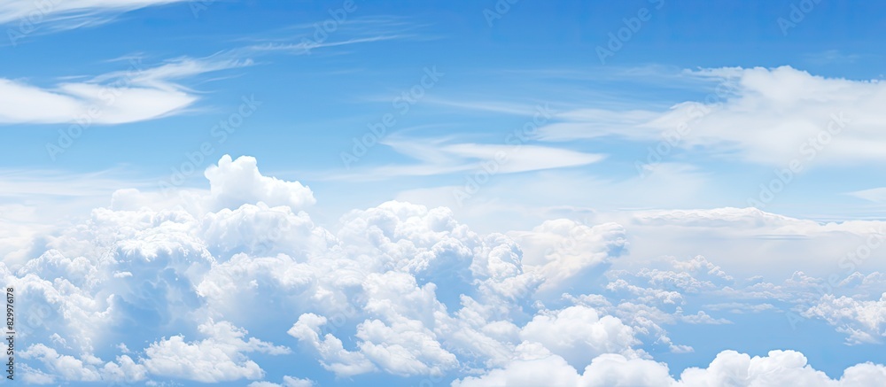 Poster a copy space image of a clear blue sky adorned with fluffy white clouds