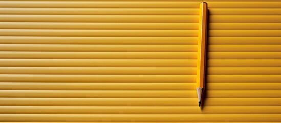 A close up image of a yellow pencil placed on a lined notebook sheet with a spiral binding creating a copy space for additional content