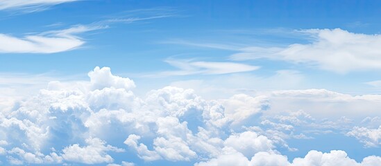 Fototapeta premium A copy space image of a clear blue sky adorned with fluffy white clouds