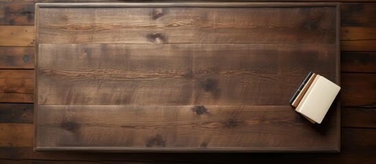 From a bird s eye perspective there is a view of an old wooden desk where a blank notebook is placed providing ample empty space for an image or text