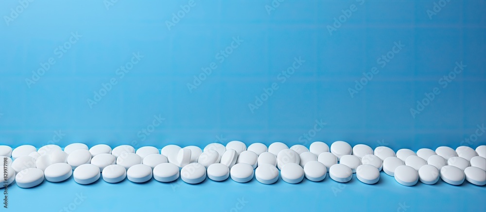 Aufkleber a blue background displaying white round tablets allowing for ample copy space image