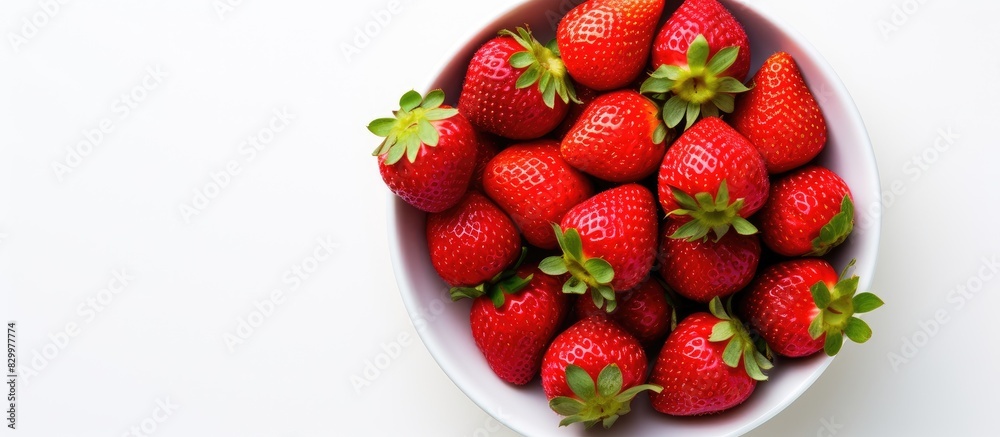 Poster A close up view from above of a plate of fresh strawberries which are part of a healthy raw diet The image is isolated on a white background and includes copy space for text or framing