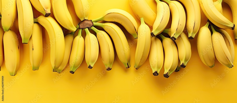 Poster copy space image of bananas arranged on a vibrant yellow background
