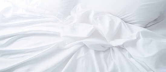 A copy space image featuring a close up view of pristine white sheets on a bed - Powered by Adobe