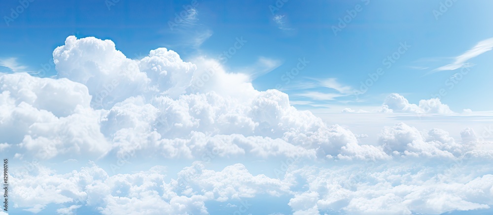 Aufkleber Daytime sky with a subtle haze and fluffy white clouds offering plenty of empty space for creative copy or images