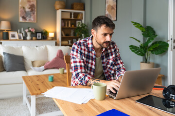 Career winner mindset. Young freelance businessman working at home. Confident dedicated male learning and educate himself for better opportunity in his business career, work online on laptop computer.
