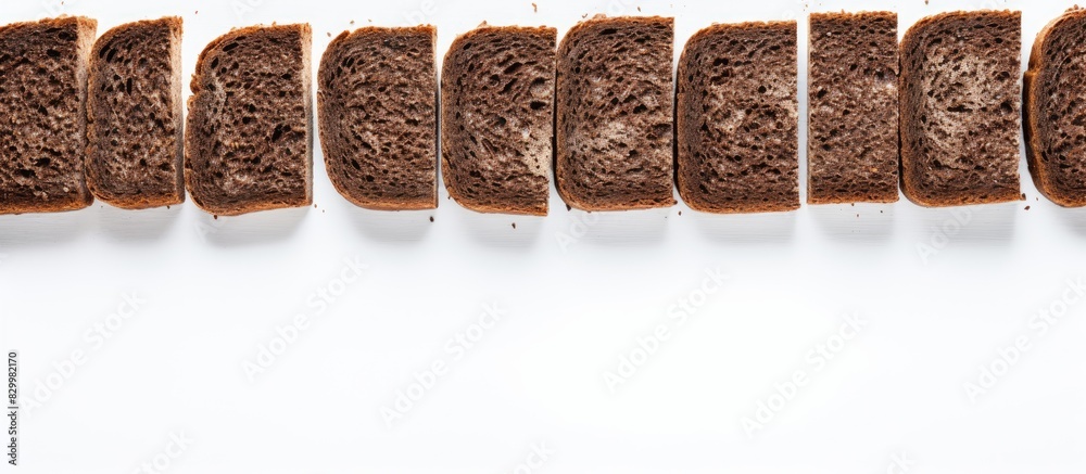 Aufkleber A food background with a view from above showing decorative edging pieces of black rye bread on a white surface creating an isolated border pattern. with copy space image