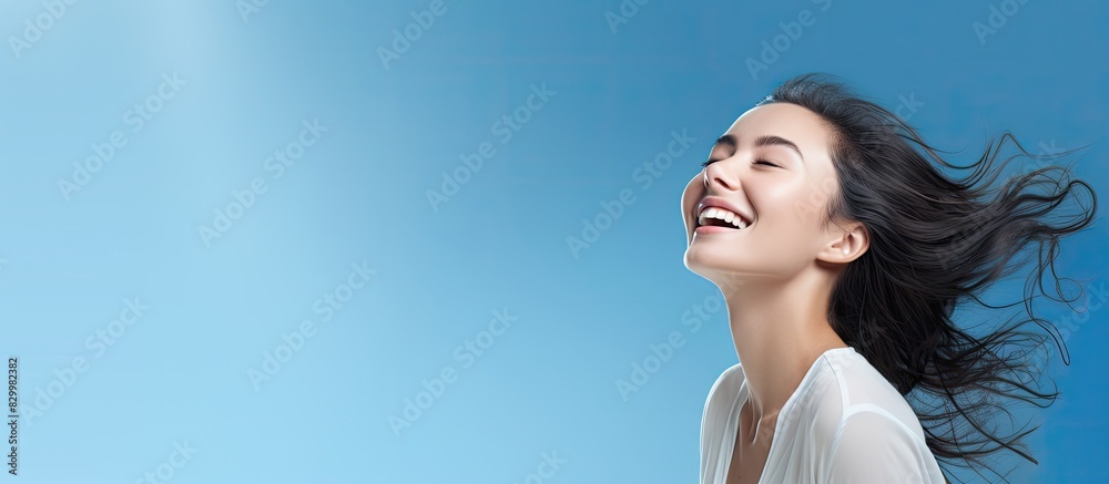 Poster copy space image of a joyful and beautiful girl showcasing a solution isolated on a vibrant blue bac