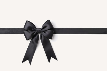 Black bow on a white background, symbol of mourning and remembrance