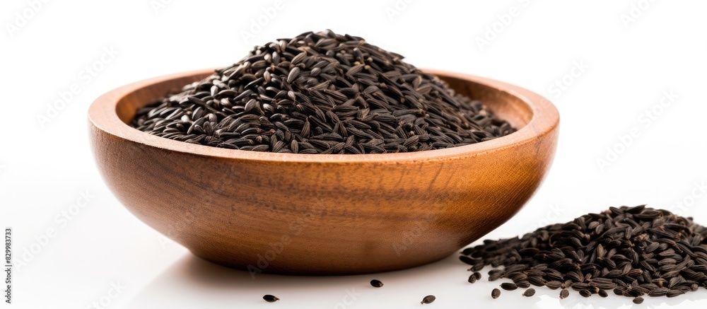 Leinwandbilder copy space image of black cumin seeds presented in a wooden bowl isolated on a white background the 