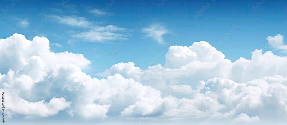 Poster daytime sky with a subtle haze and fluffy white clouds offering plenty of empty space for creative c