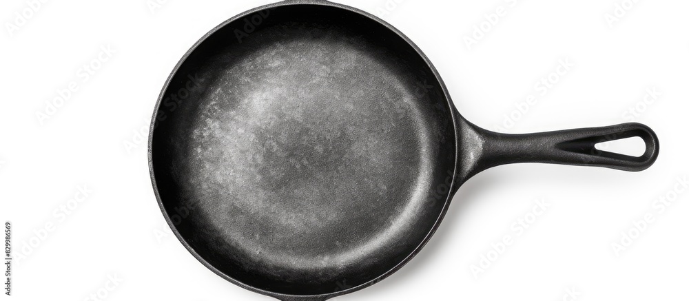 Poster a cast iron frying pan is shown in a copy space image against a white isolated background