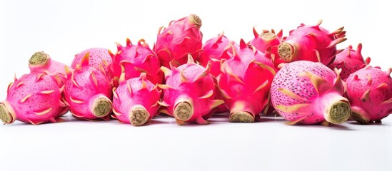 Dragon fruits arranged on a white surface with plenty of empty space around the fruits for graphical or textual additions. with copy space image. Place for adding text or design
