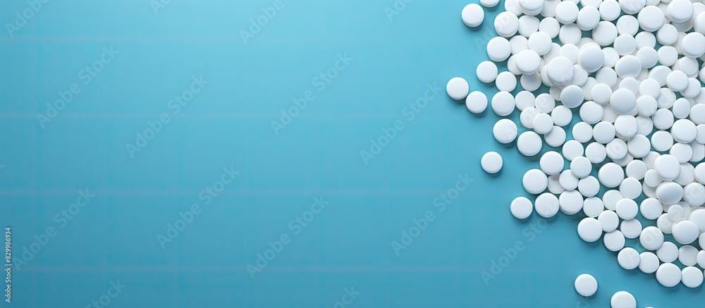 Wall mural A blue background displaying white round tablets allowing for ample copy space image