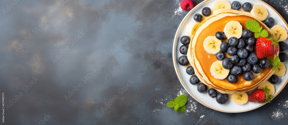 Poster a top down view of delicious buttermilk pancakes adorned with ripe banana slices juicy blueberries a