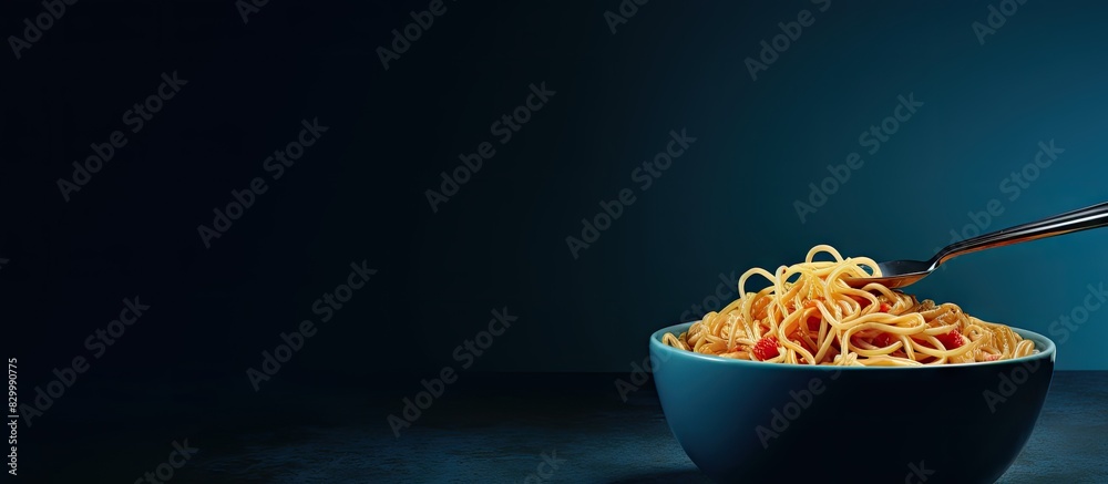 Poster A fork holds instant noodles on a dark blue bowl while copy space is available on the left side of the image